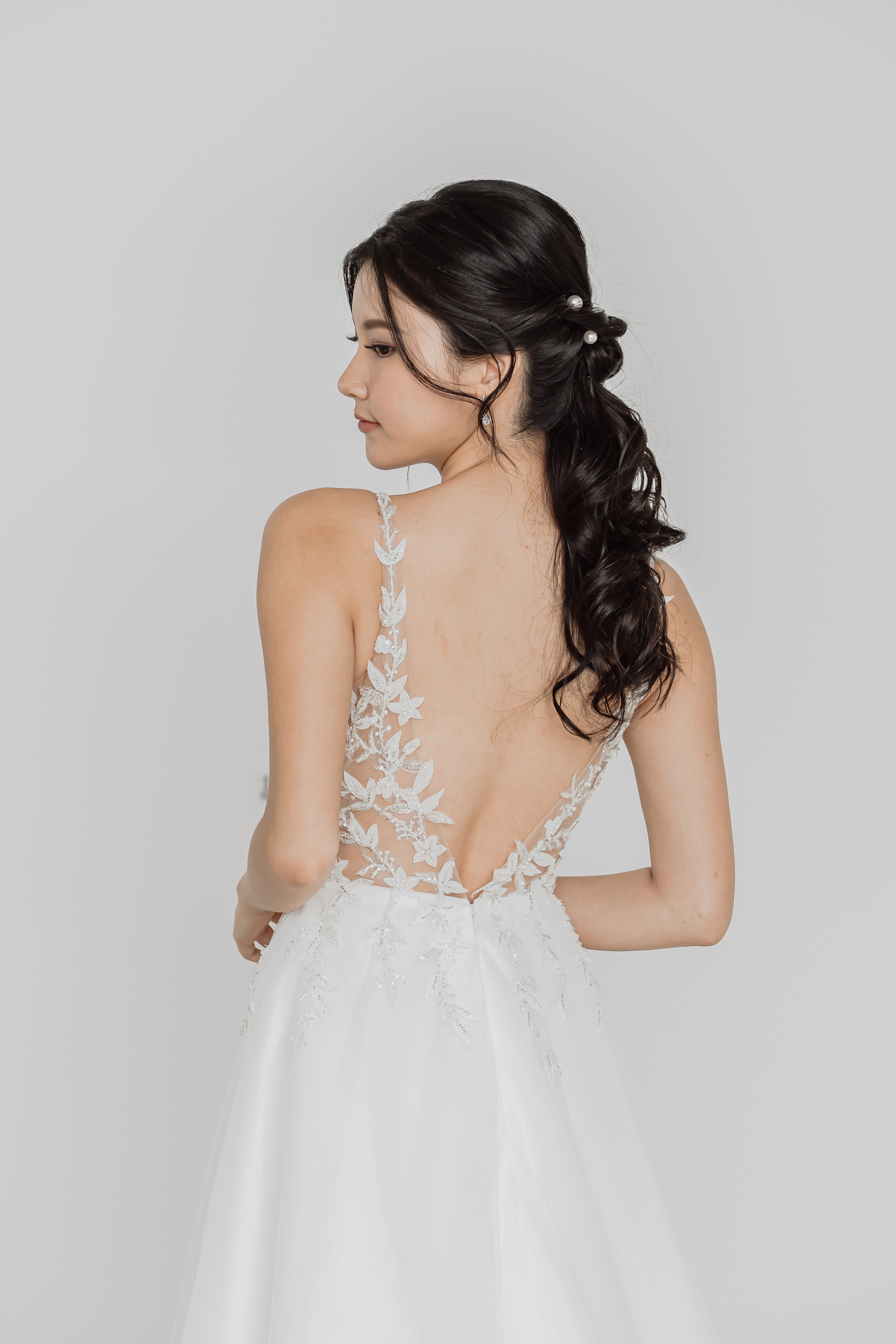 Close-up of Mindy bridal gown with beaded leafy appliqués