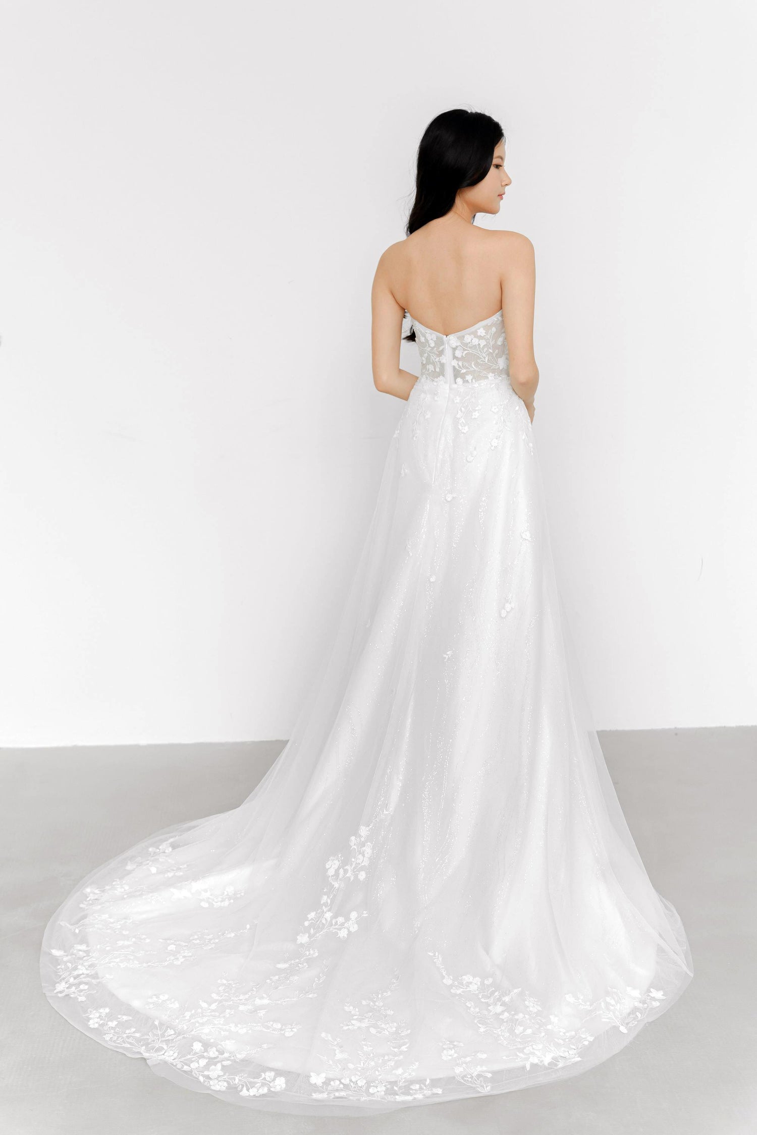 Mirelle bridal gown train showcasing the shimmering glitter fabric and graceful flowing train