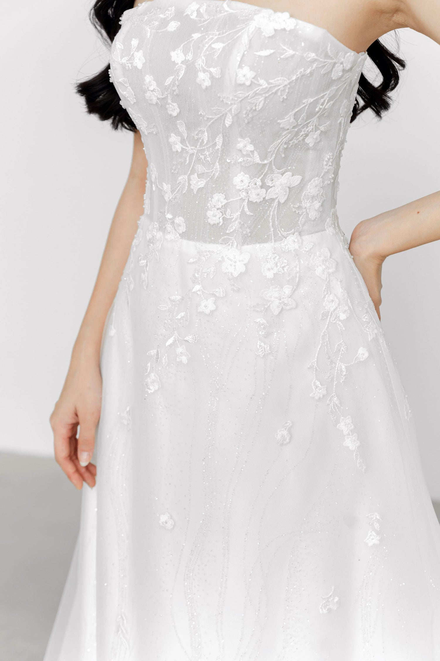 Close-up of Mirelle wedding dress highlighting the delicate floral and vine lace detailing