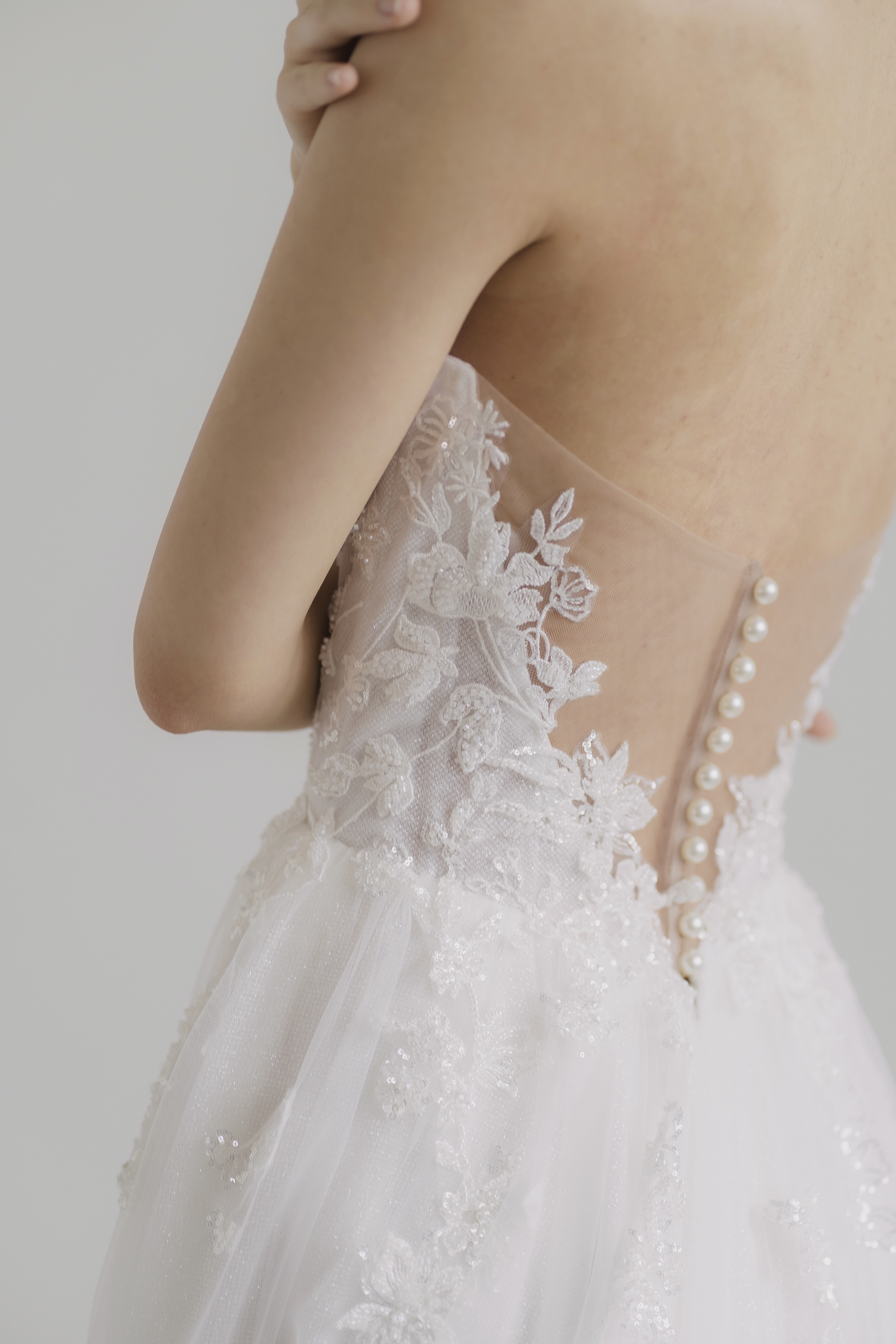 Miriam bridal gown side view with intricate beaded lace detailing