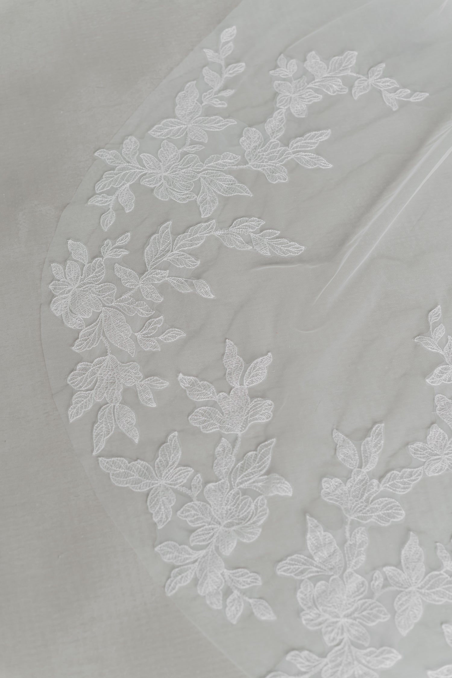 Close-up of Noelle wedding gown highlighting the detachable lace tulle train