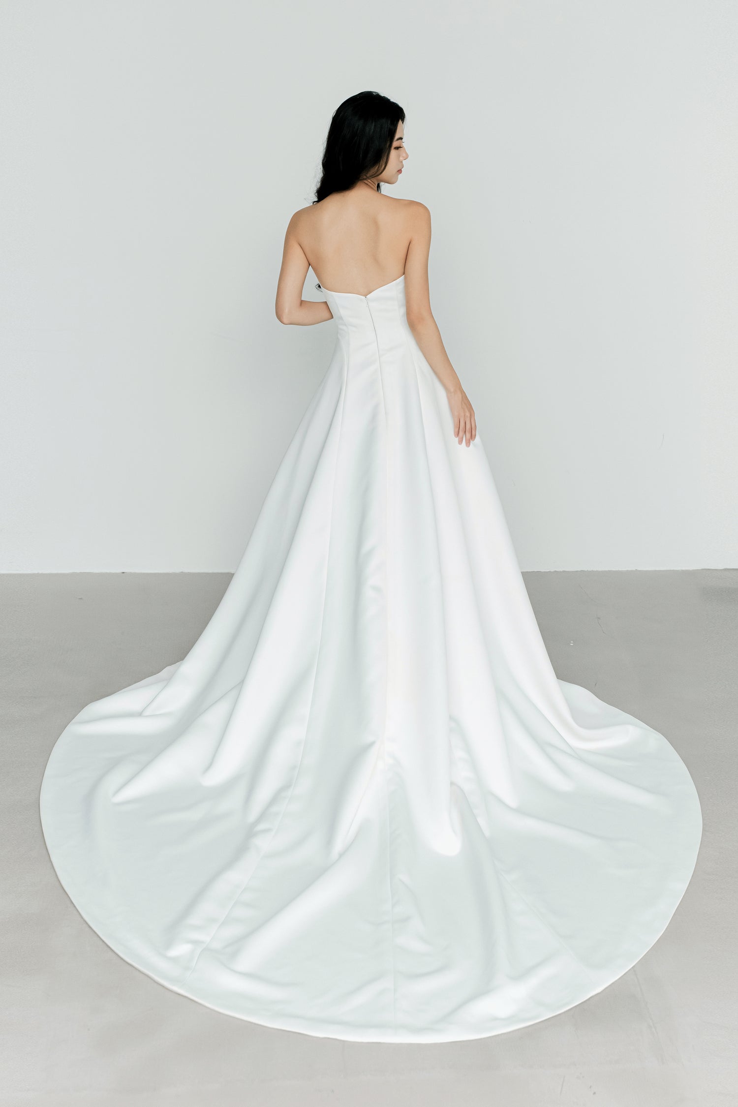 Oakley wedding gown train showcasing the luxurious satin fabric and graceful flowing train