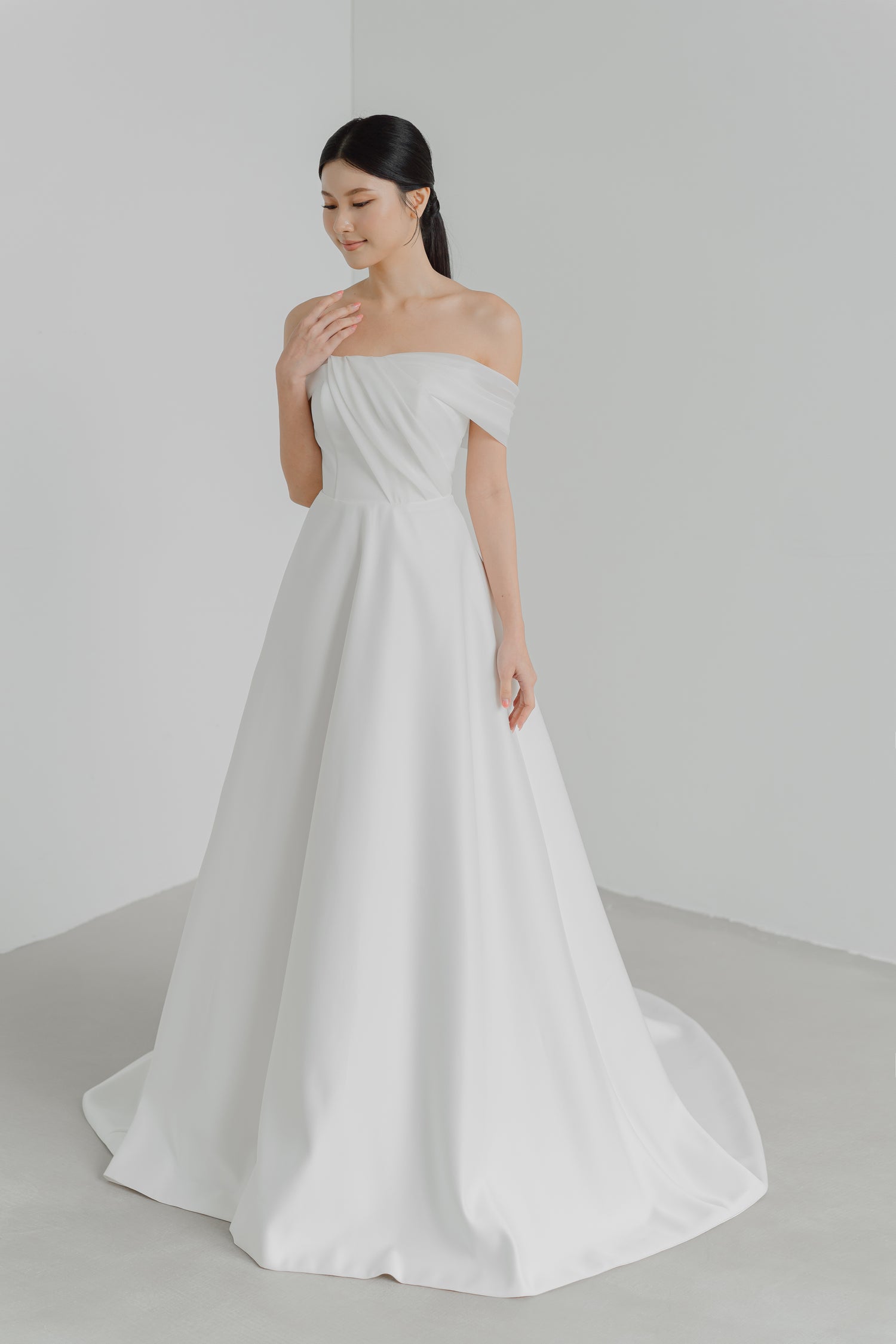 Odena bridal gown front view with a sleek strapless neckline and flowing organza silhouette