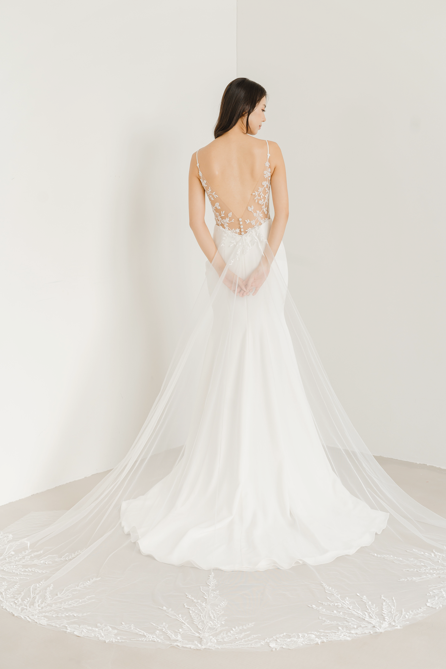 Close-up of Raina bridal gown showcasing the low V-back with delicate lace detailing
