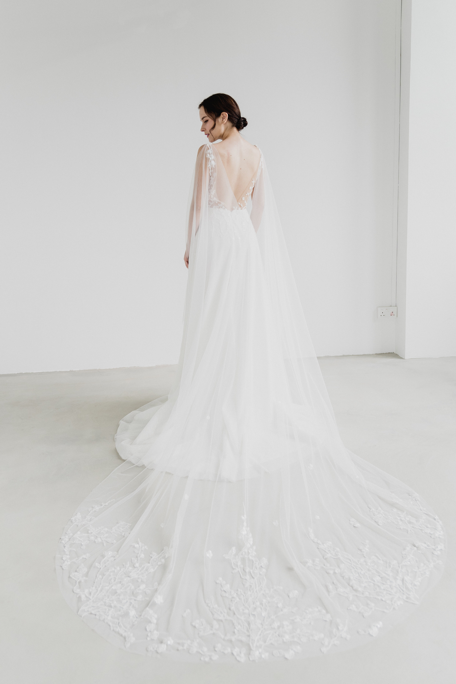 Reimi bridal dress featuring a detachable cape train