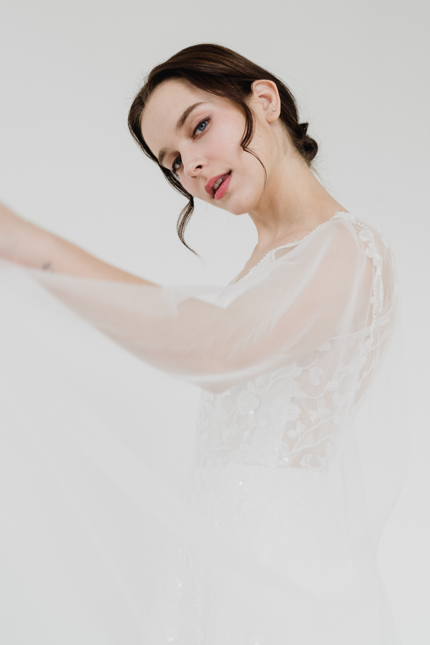 Reimi wedding gown styled with a detachable cape train