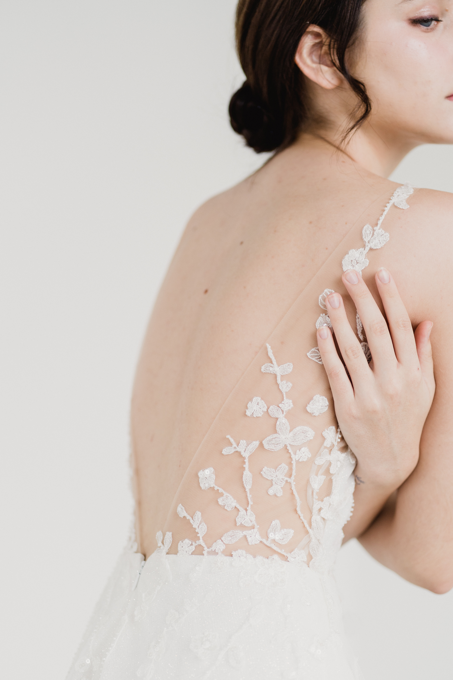 Close-up of Reimi wedding gown with delicate beaded lace