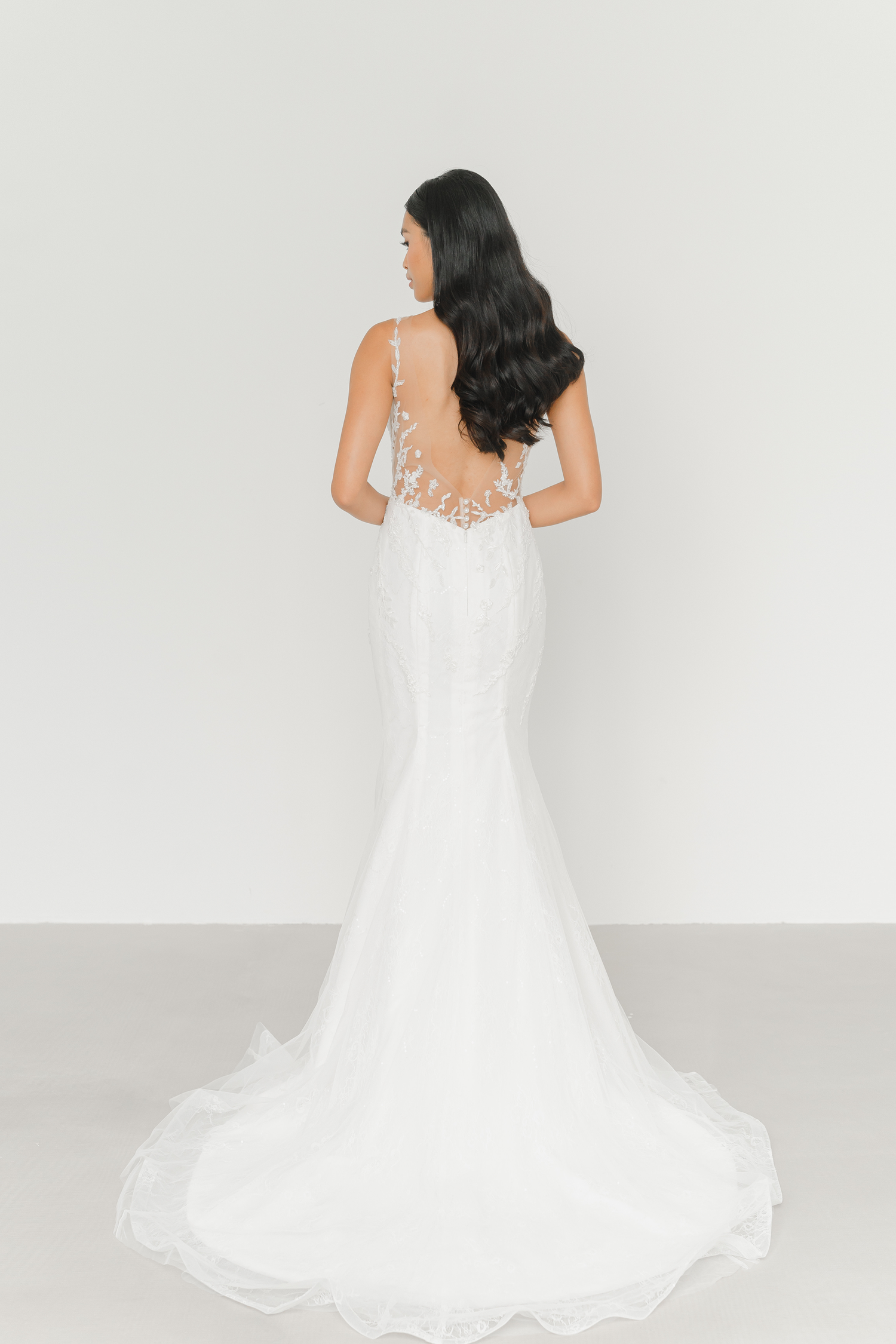 Close-up of Rhea wedding gown highlighting the dramatic low-back design