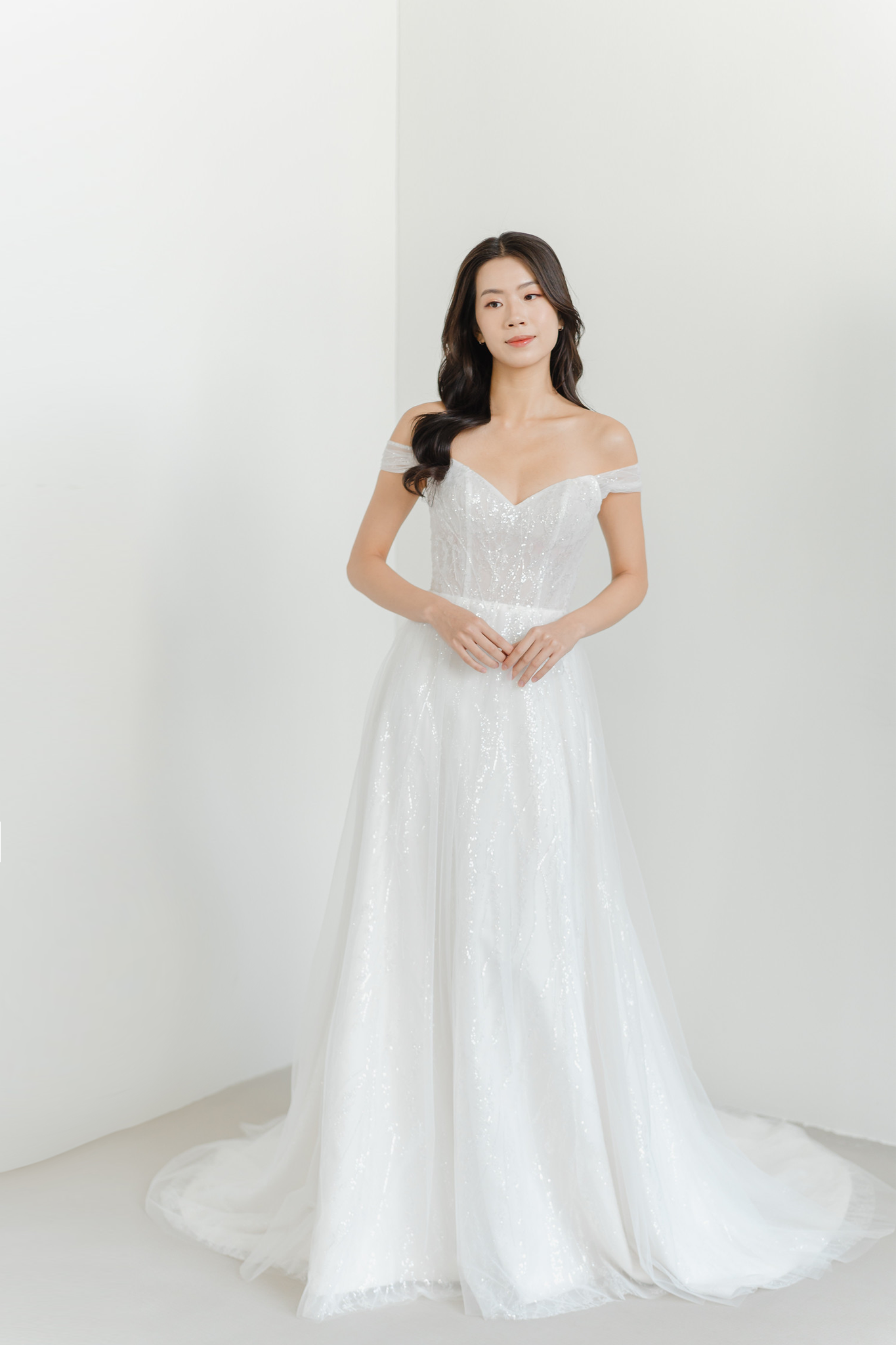 Riley bridal gown featuring shimmering sequinned tulle and an elegant off-shoulder design