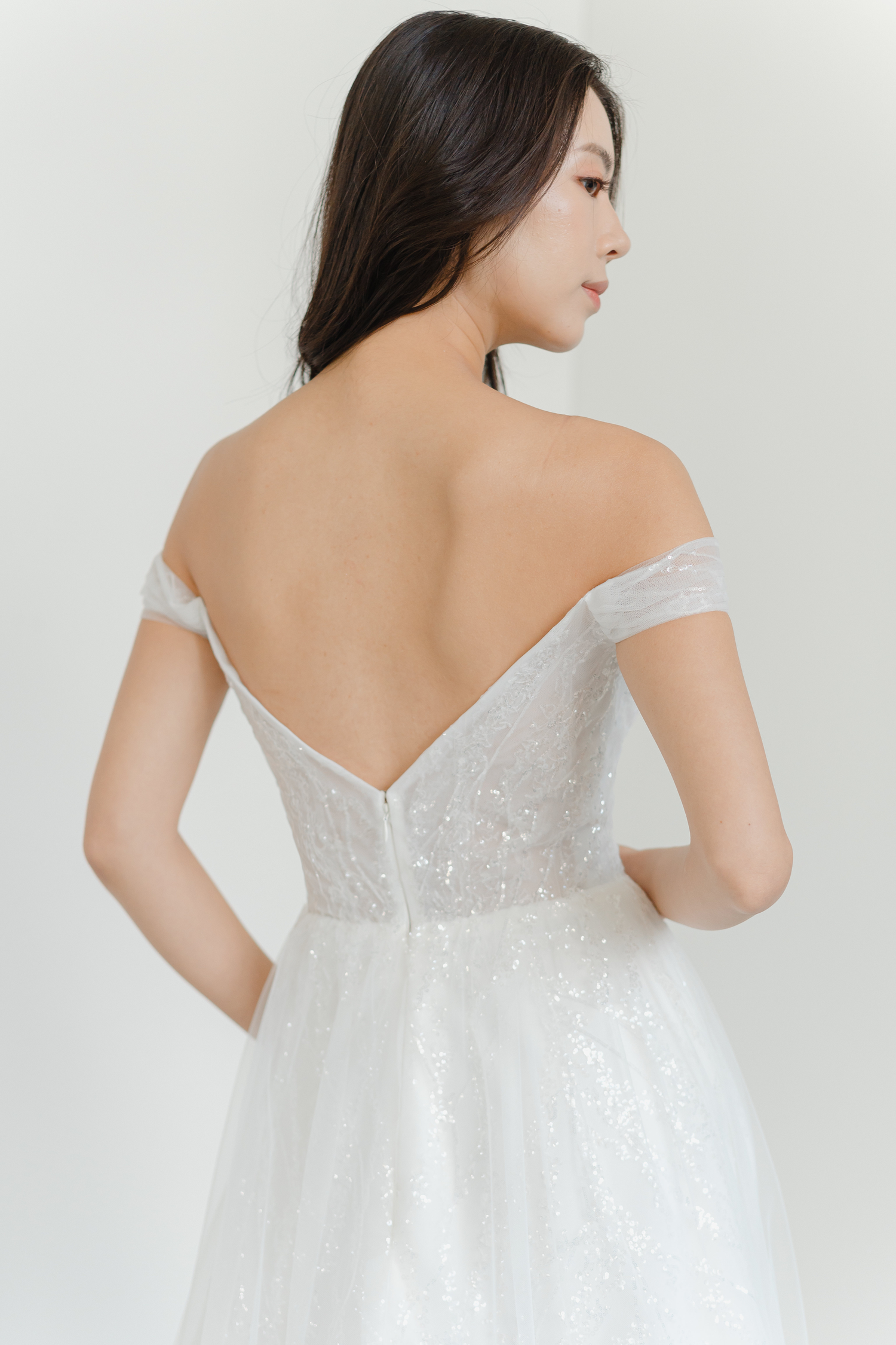Close-up of Riley wedding dress with shimmering sequinned tulle detailing
