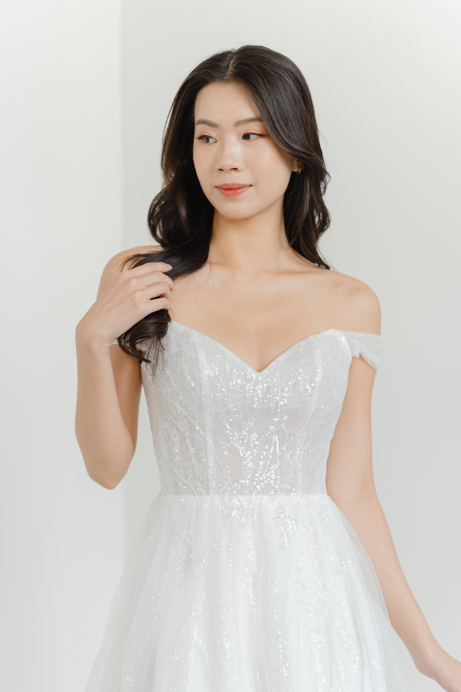 Riley wedding dress front view with an off-shoulder neckline and soft A-line silhouette