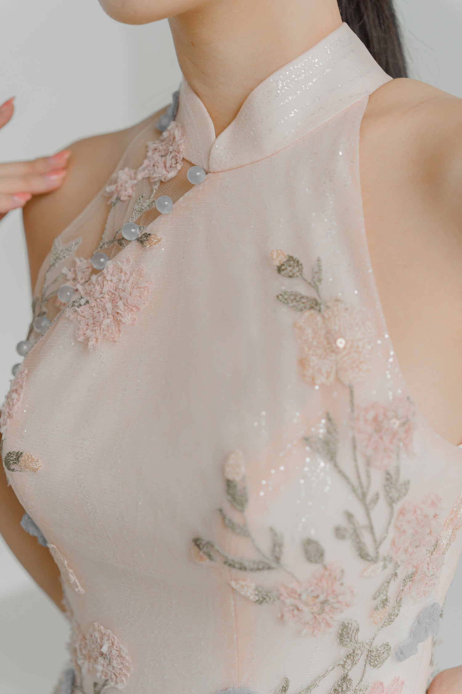 Close-up of Rowan wedding cheongsam highlighting the delicate pastel floral lace