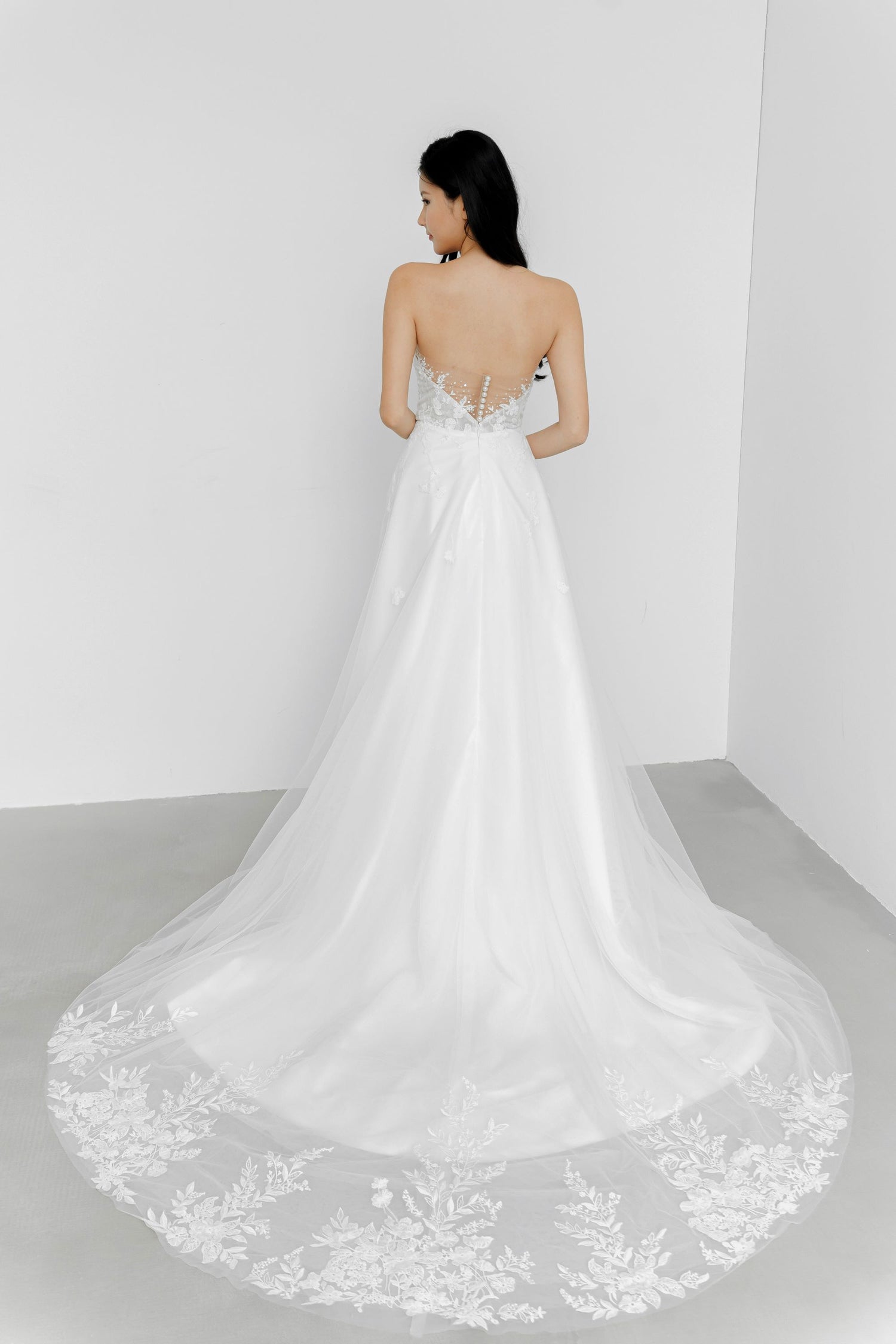 Ruth wedding dress back view with an illusion lace panel and pearl buttons