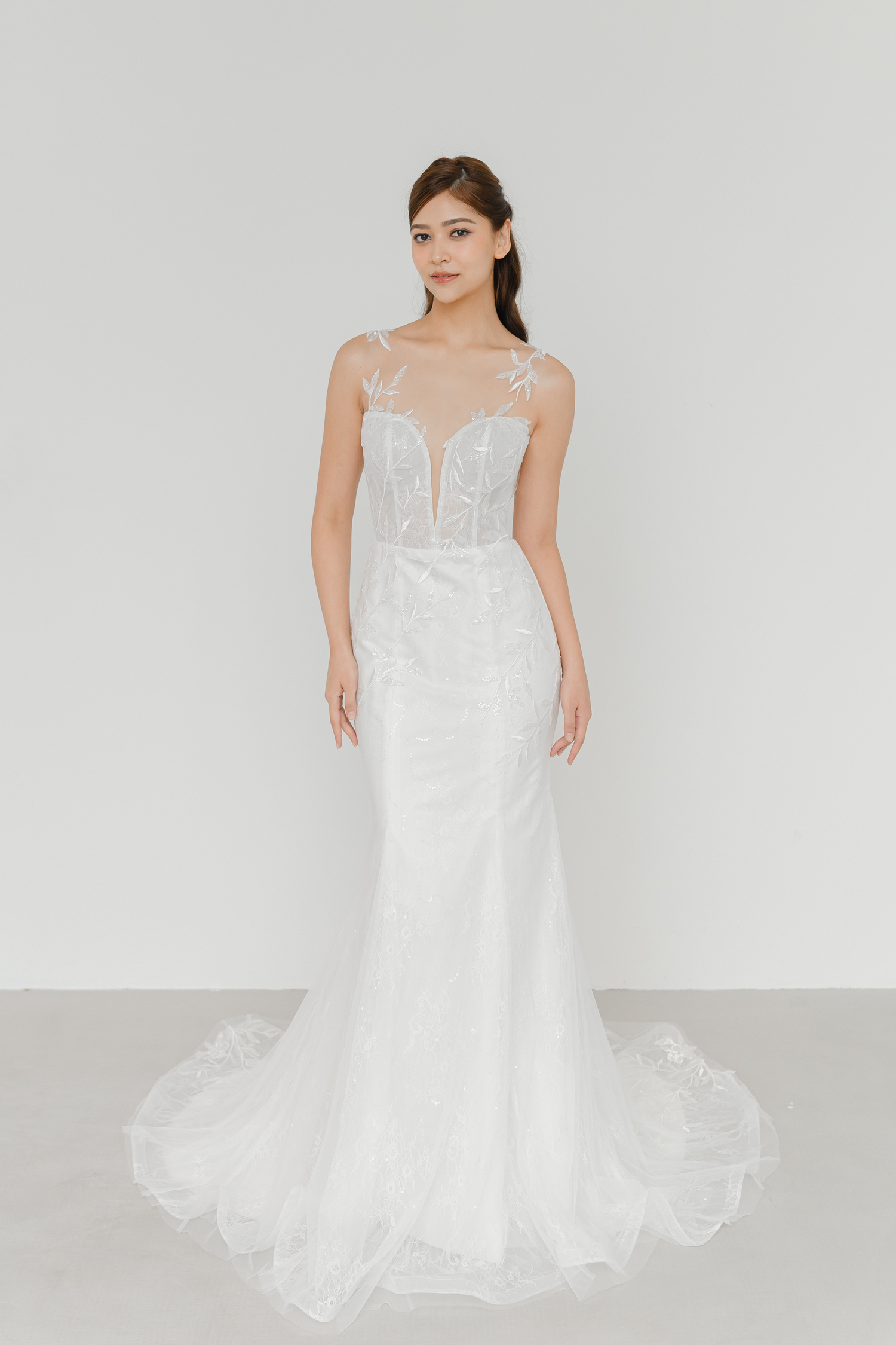 Sally wedding dress front view with an illusion neckline and sequinned leafy lace