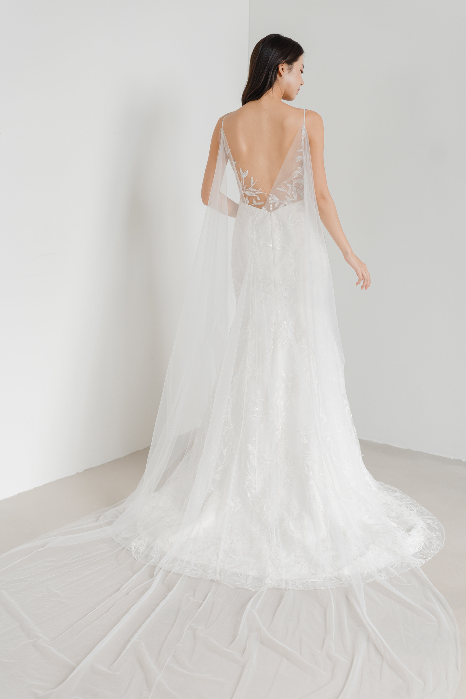 Shannon bridal gown train showcasing shimmering leafy lace appliqués and an elegant flowing train