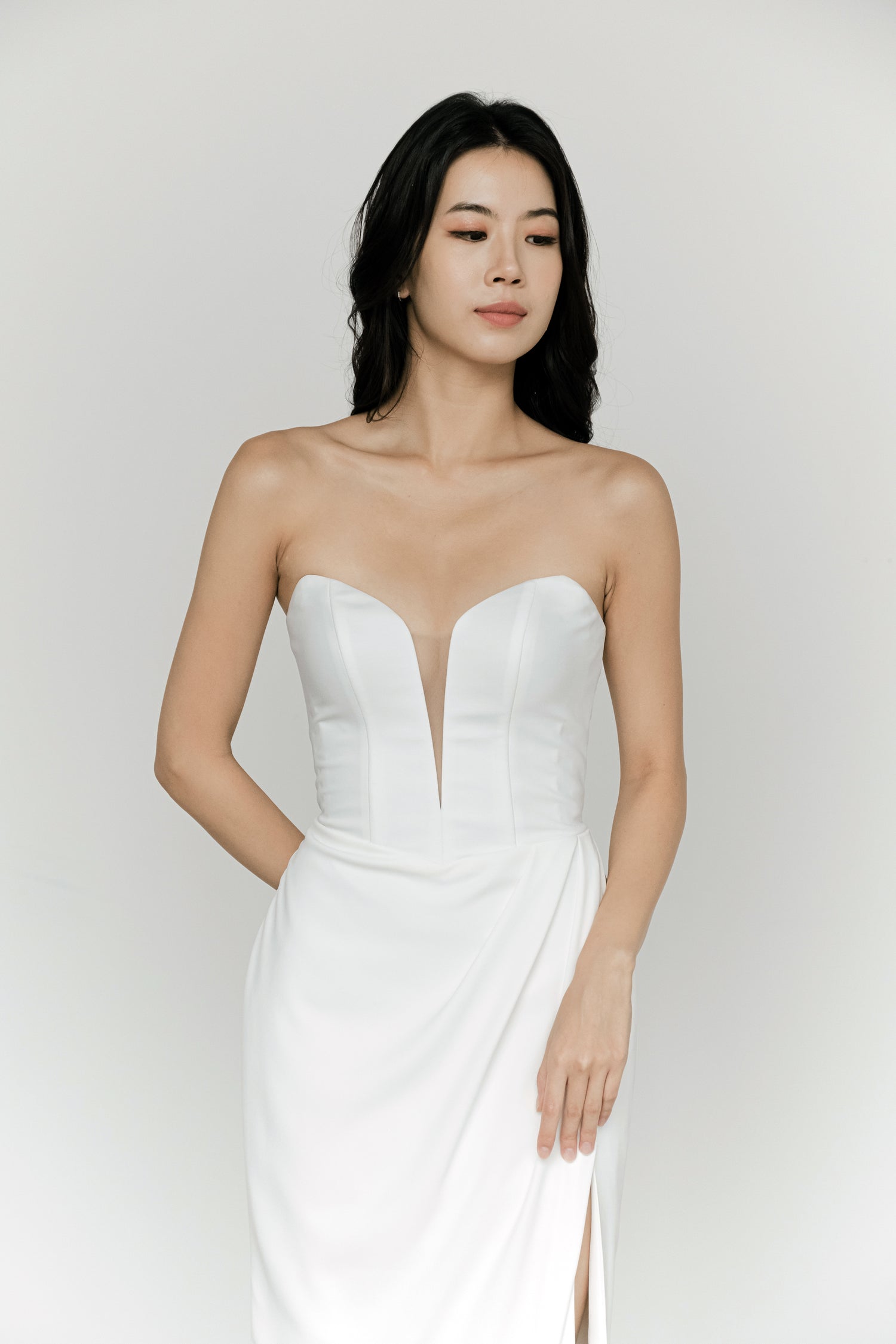 Sybil bridal evening gown front view with elegant draping and a fitted silhouette