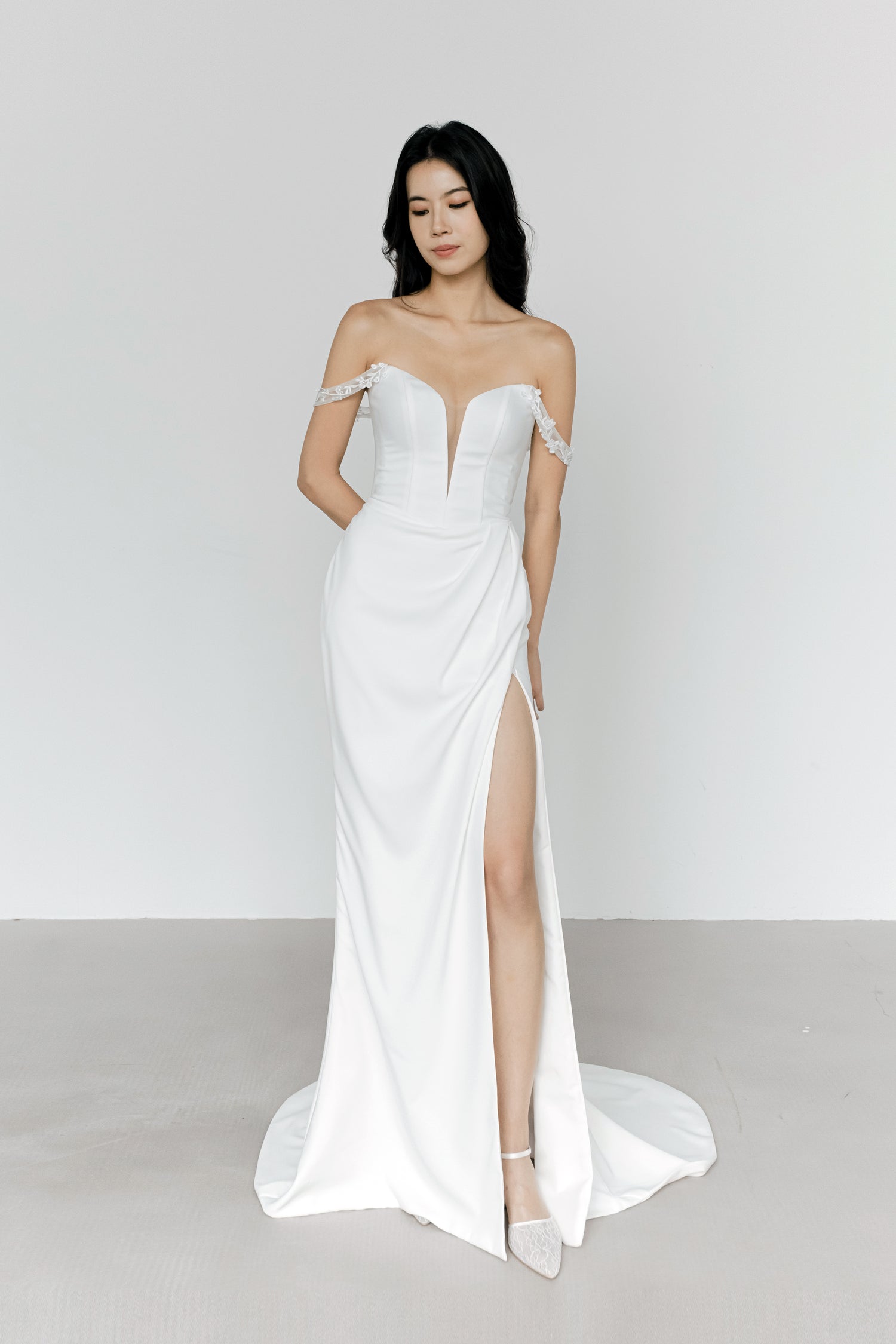 Sybil bridal evening gown side view showcasing the sleek silhouette and thigh-high slit