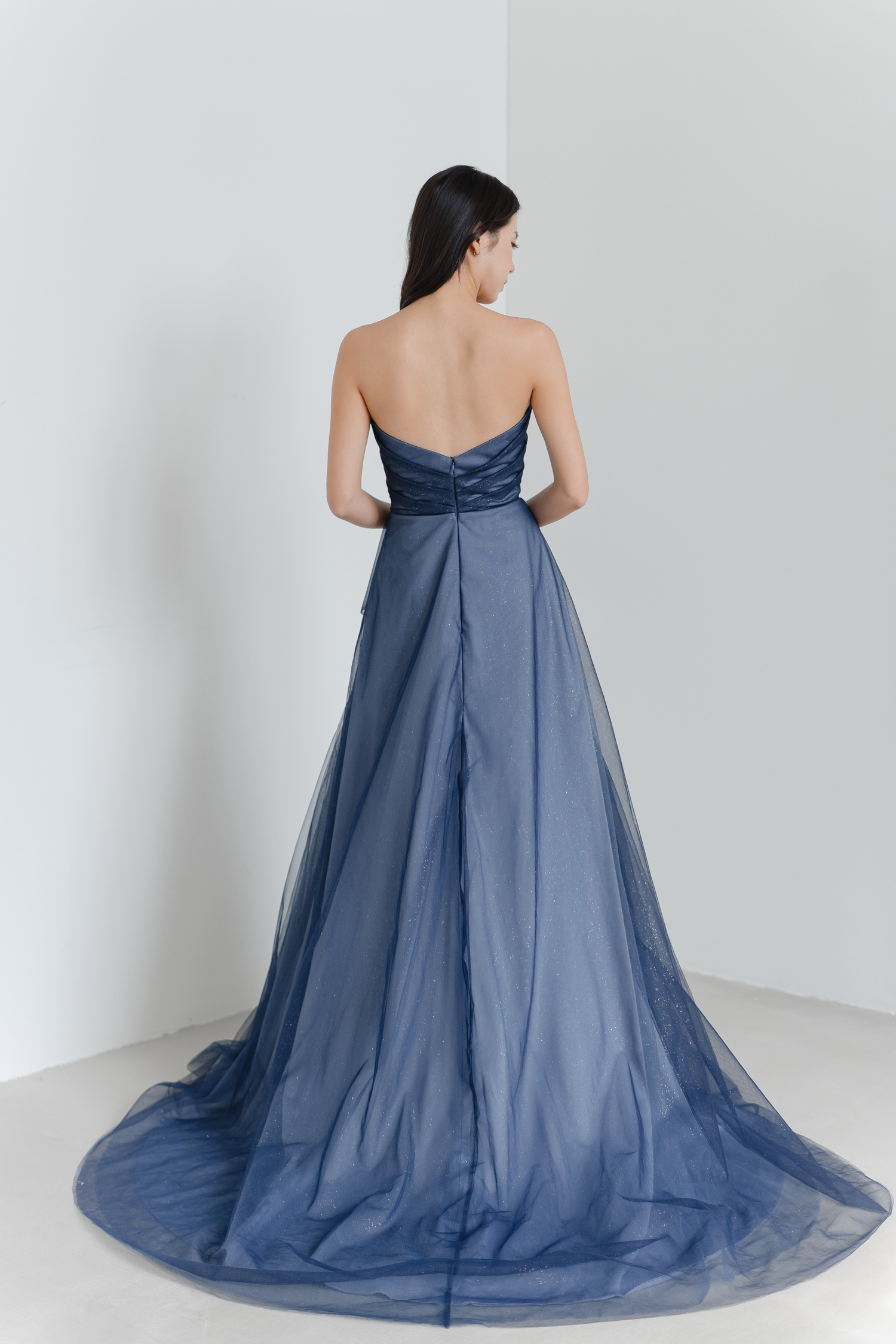 Sylvie bridal evening gown showcasing the flowing train and subtle shimmering details