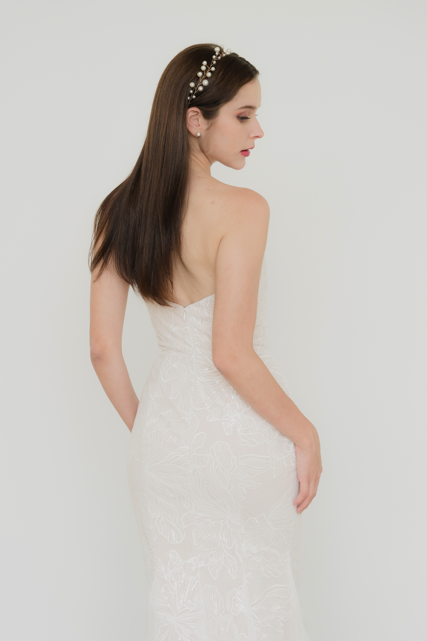Close-up of Taylor wedding dress highlighting the floral lace-patterned tulle