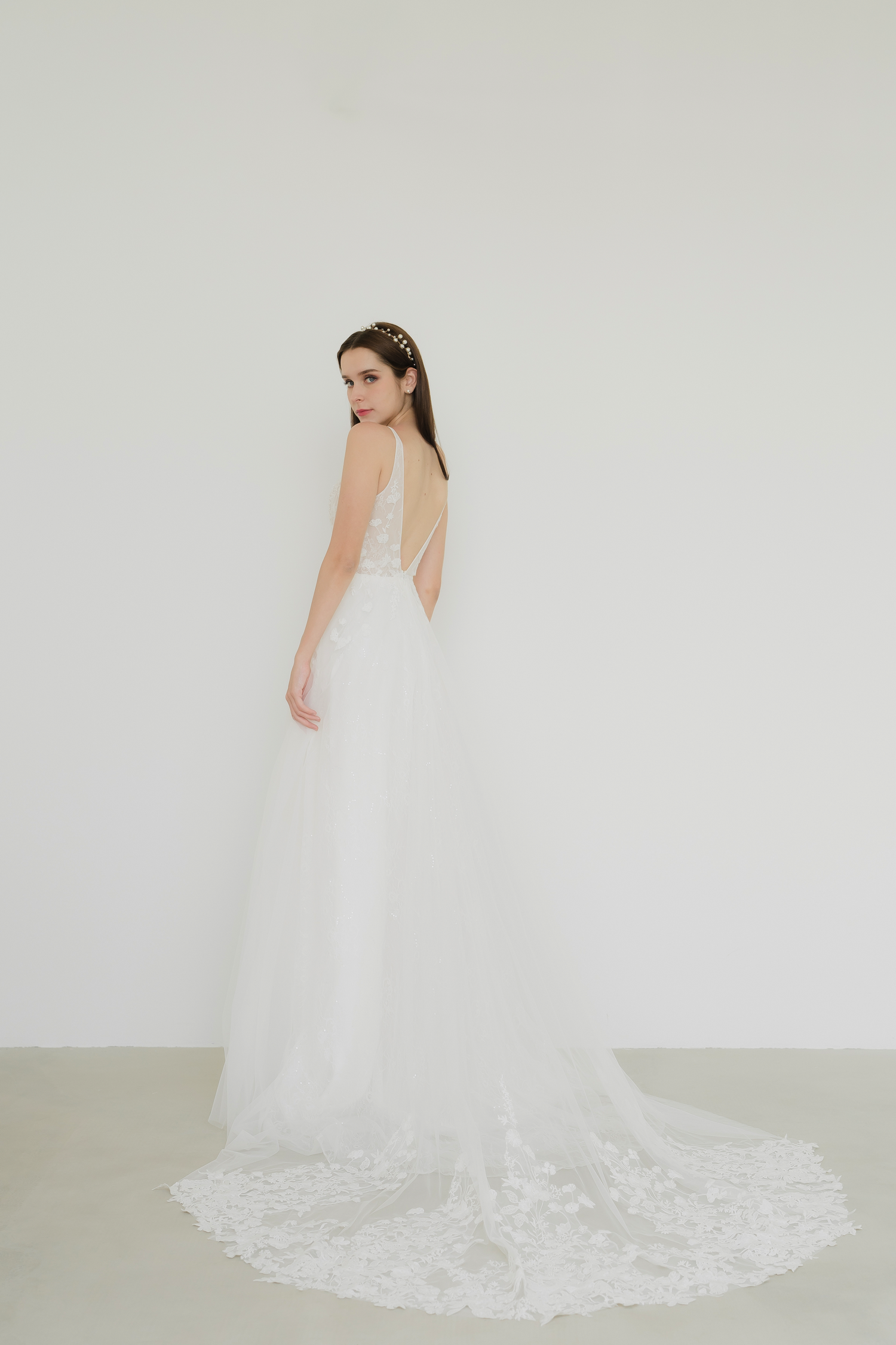 Close-up of Tena wedding gown highlighting the delicate lace motifs cascading across the bodice and skirt
