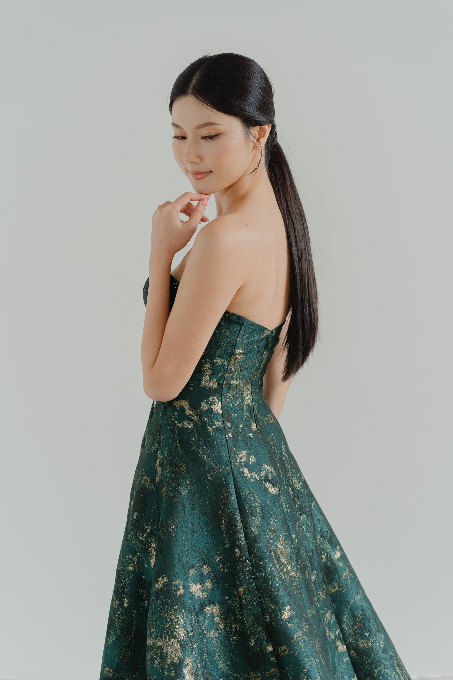 Close-up of Thalia evening dress highlighting the intricate jacquard fabric with champagne accents