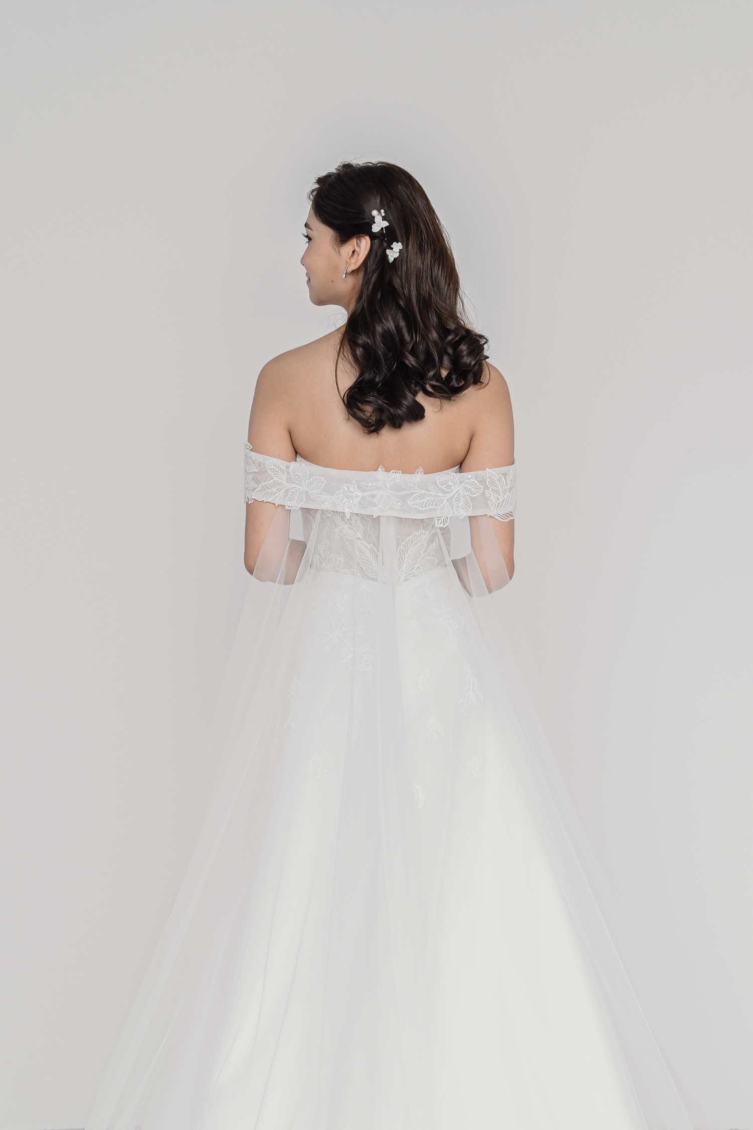 Trudy bridal gown back view with a detachable off-shoulder cape train