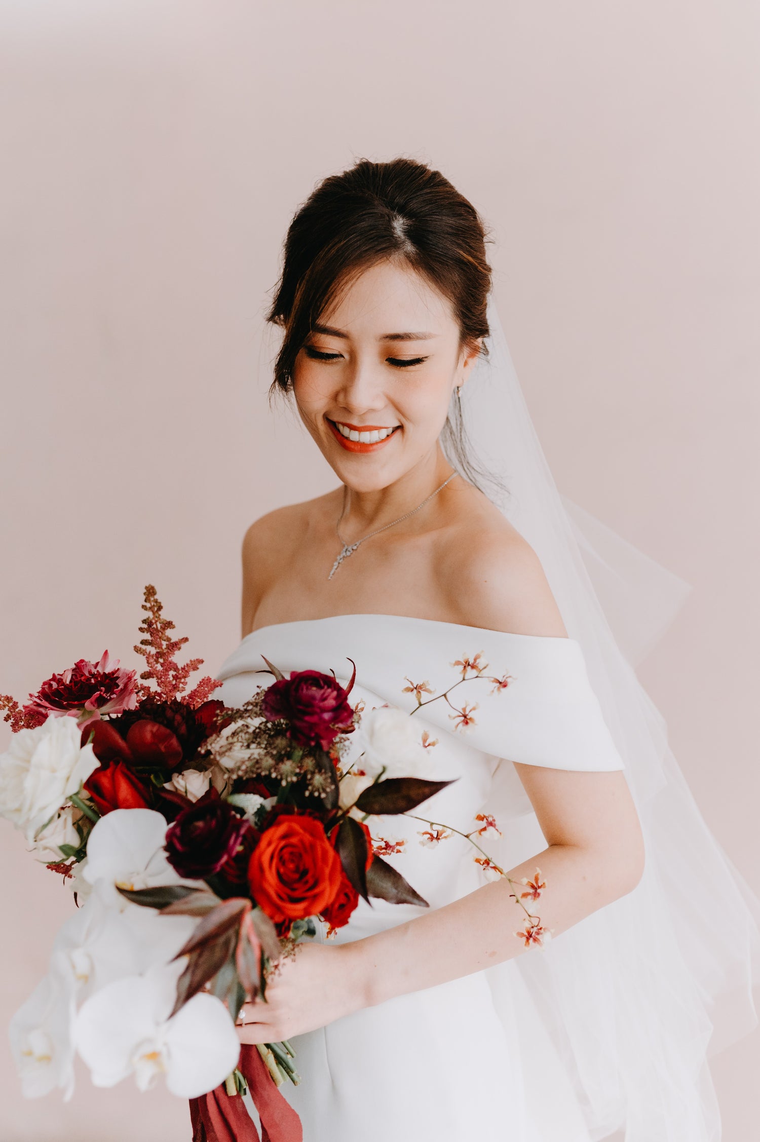 Bride wearing a minimalist wedding gown to showcase WeddingCrafters' wedding gown packages in Singapore.