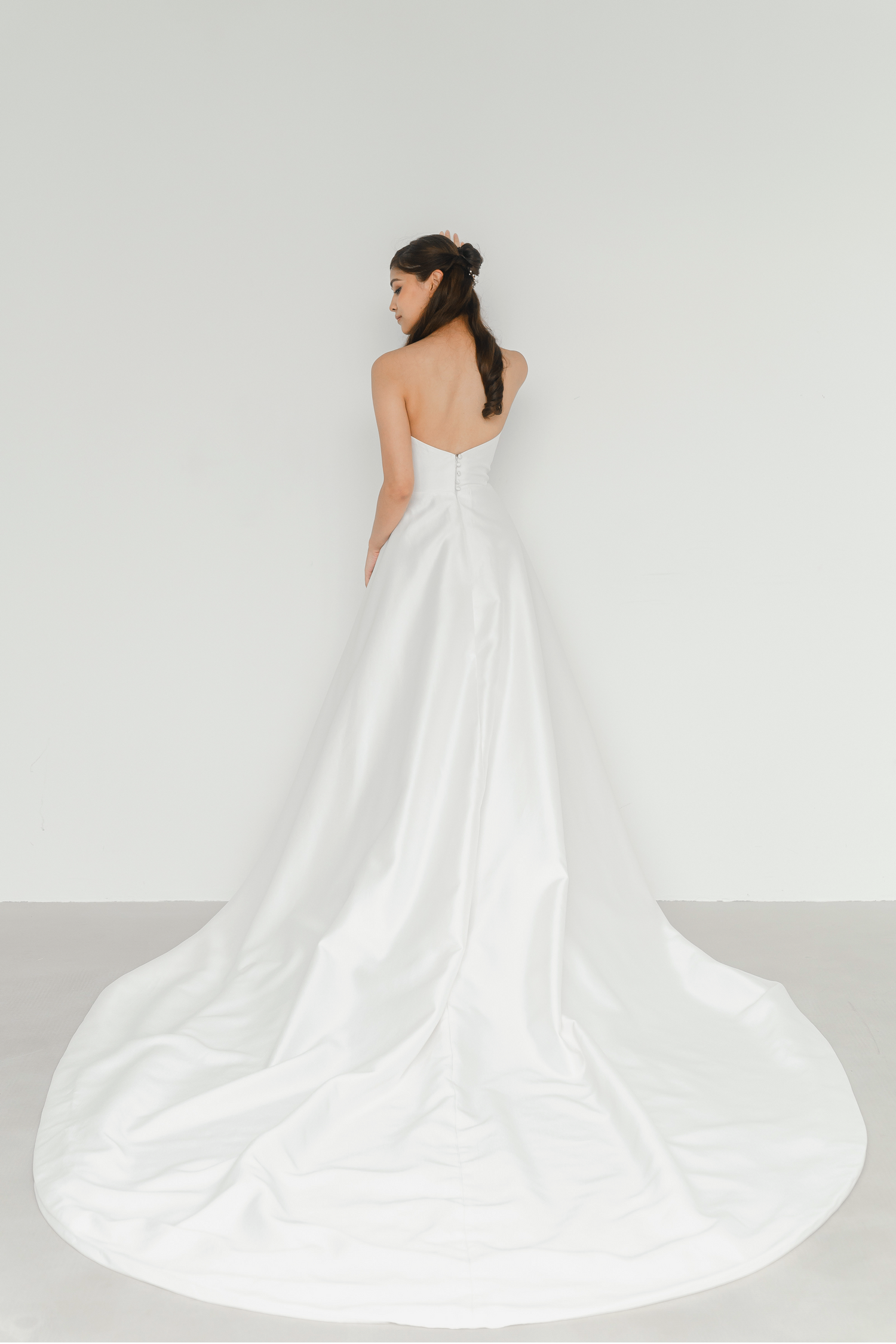 Willa bridal gown back view with delicate button detailing and a long train