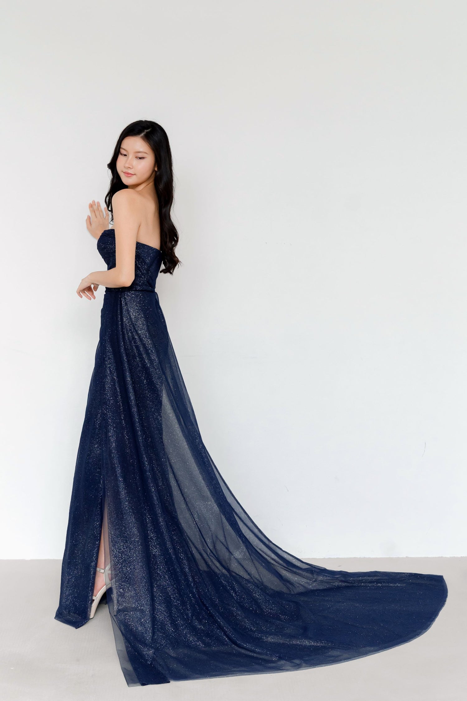 Zanda bridal evening gown side view showcasing the fluid side train and fitted silhouette